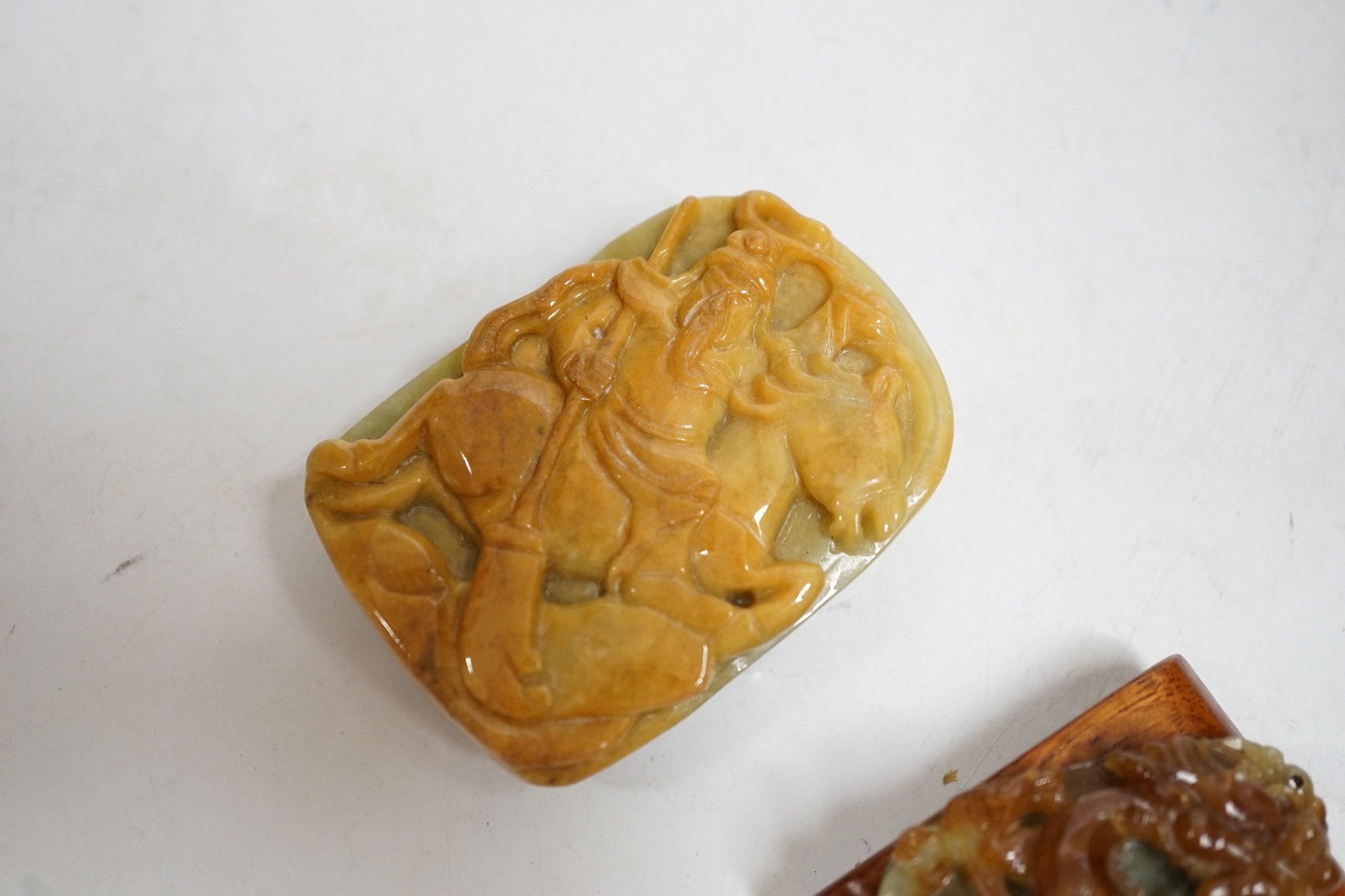 A Chinese jadeite belt buckle and a plaque carved with a dragon, largest 6.5cm high. Condition - good